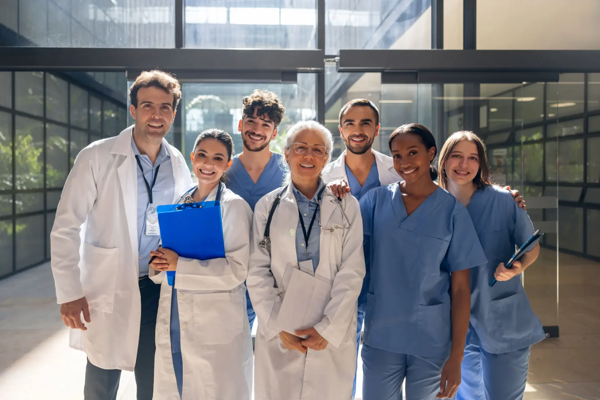 A diverse group of medical professionals standing together in a hospital.