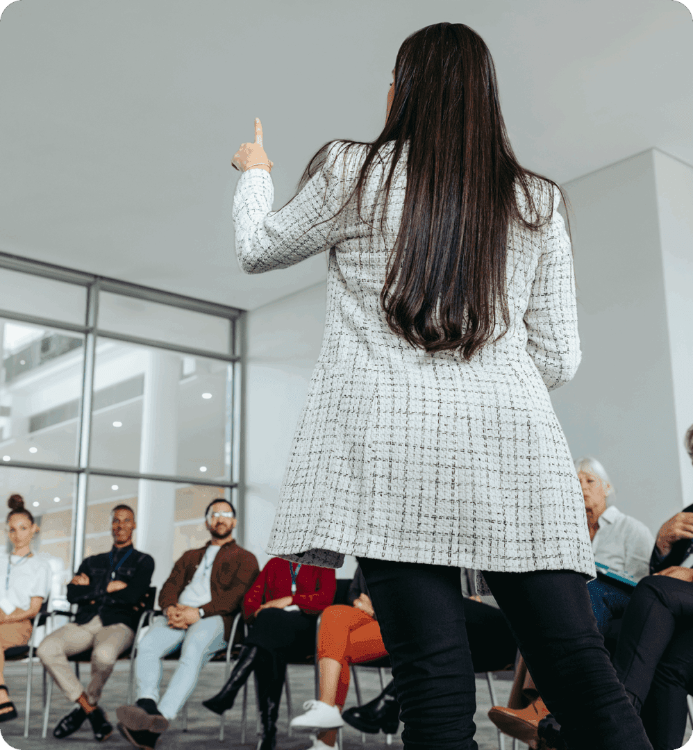 Speaker addressing audience in modern conference room