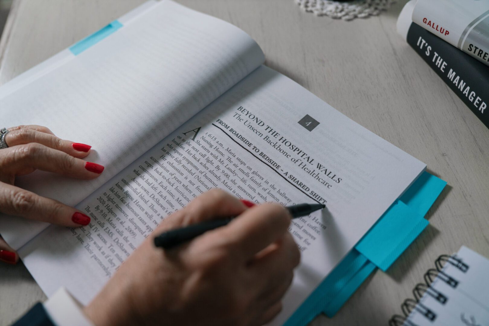 Person editing a printed manuscript with a pen.
