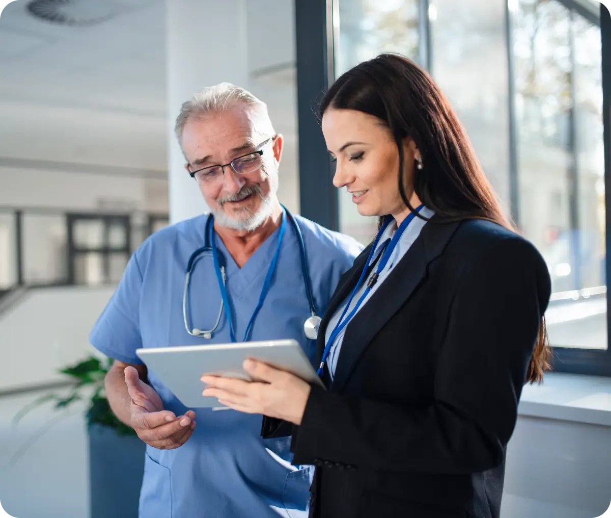 Doctor and administrator reviewing digital tablet