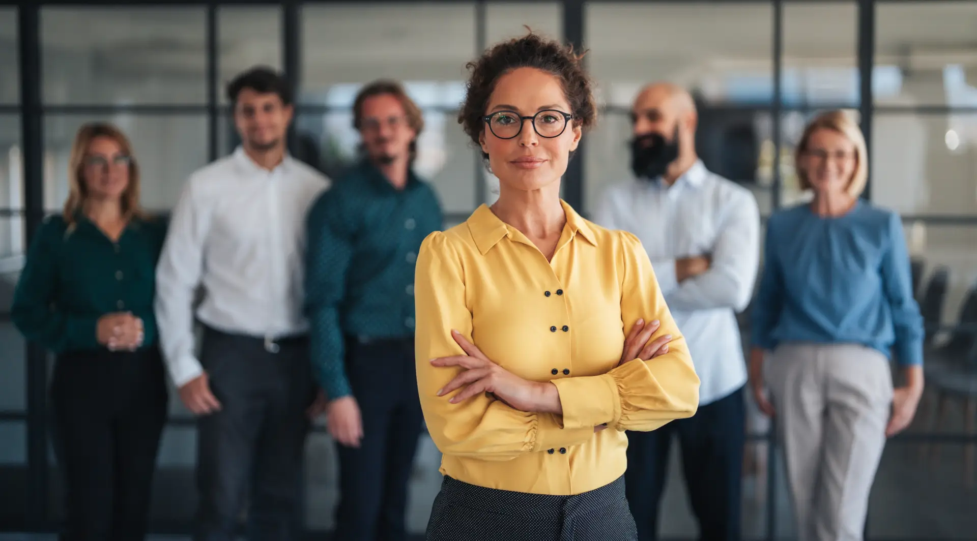Confident businesswoman leading diverse office team