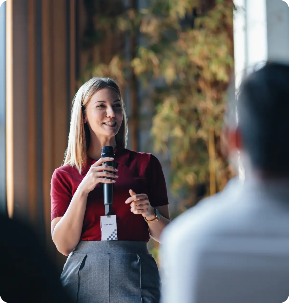 Female speaker holding microphone at conference