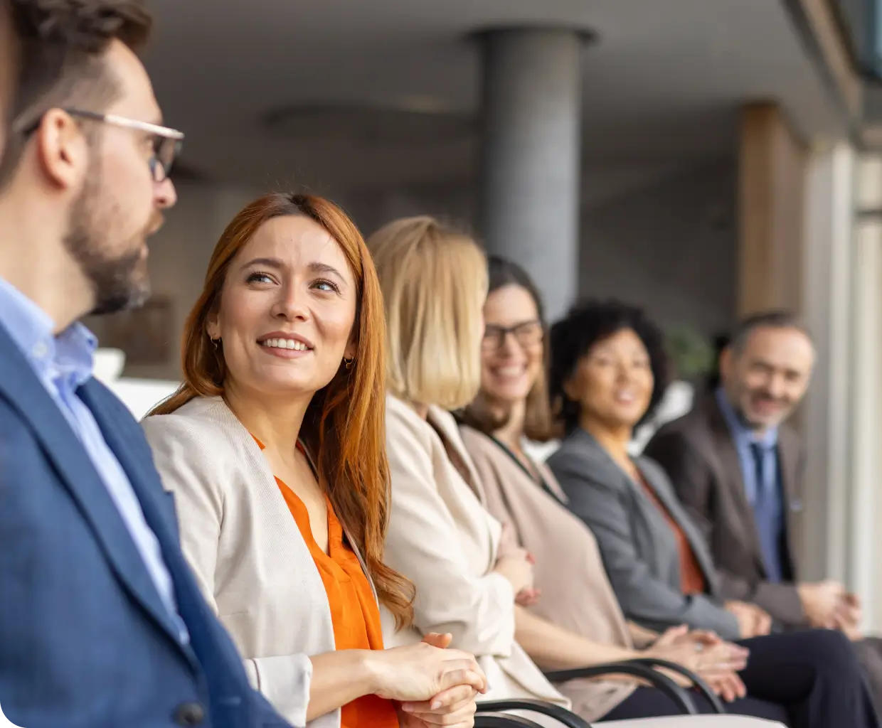 Smiling professionals seated in office waiting area